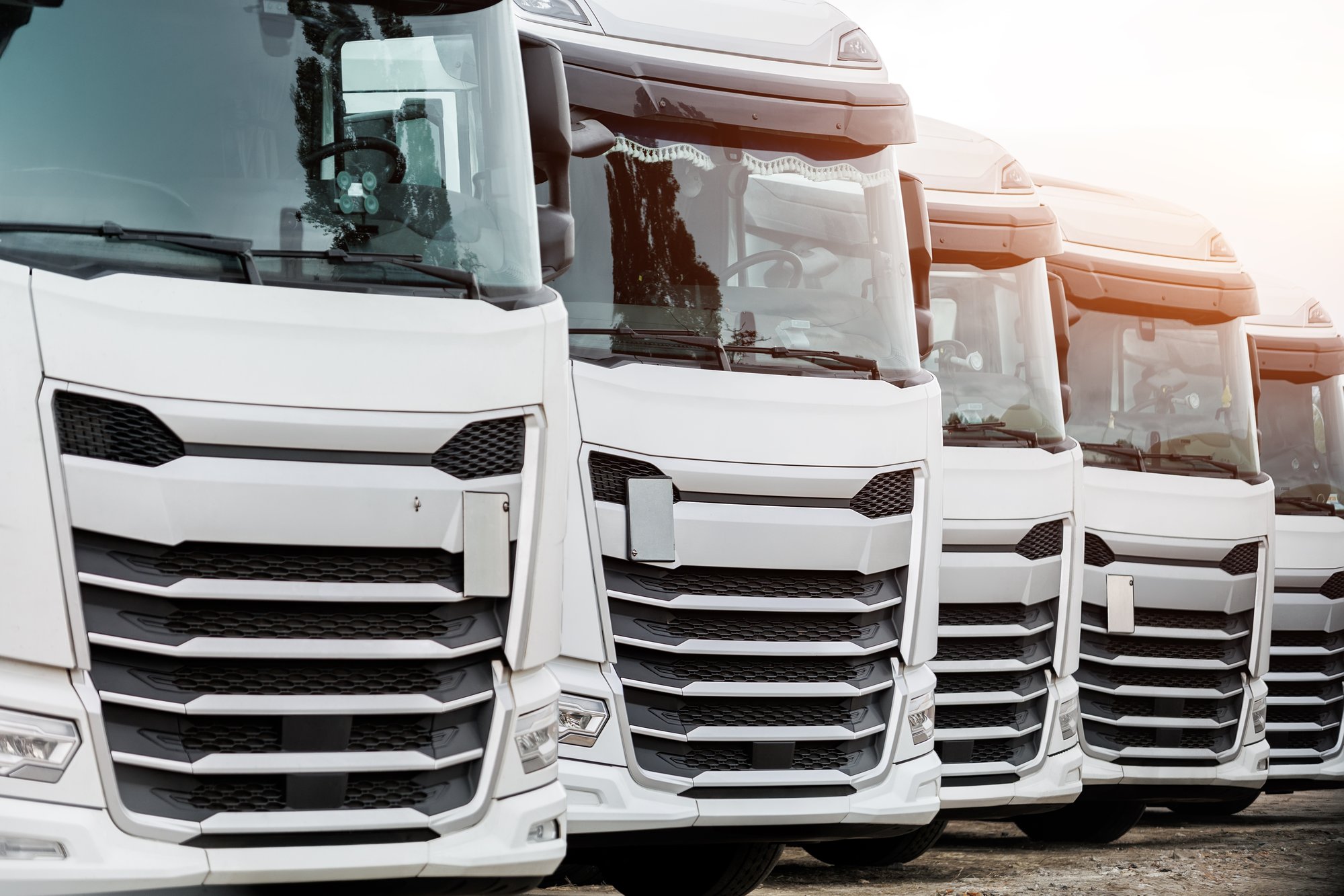 row of delivery trucks electric fleet vehicles